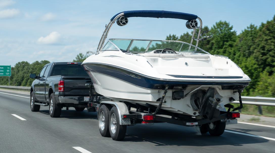 Boat on a trailer being towed along a highway