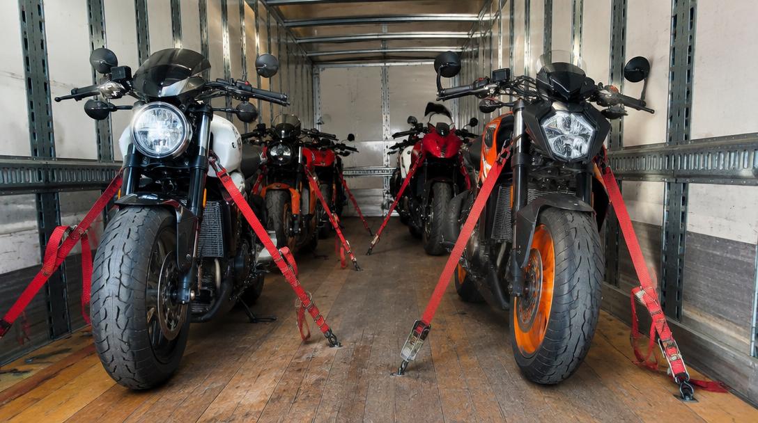 Motorcycles strapped down inside a transport trailer